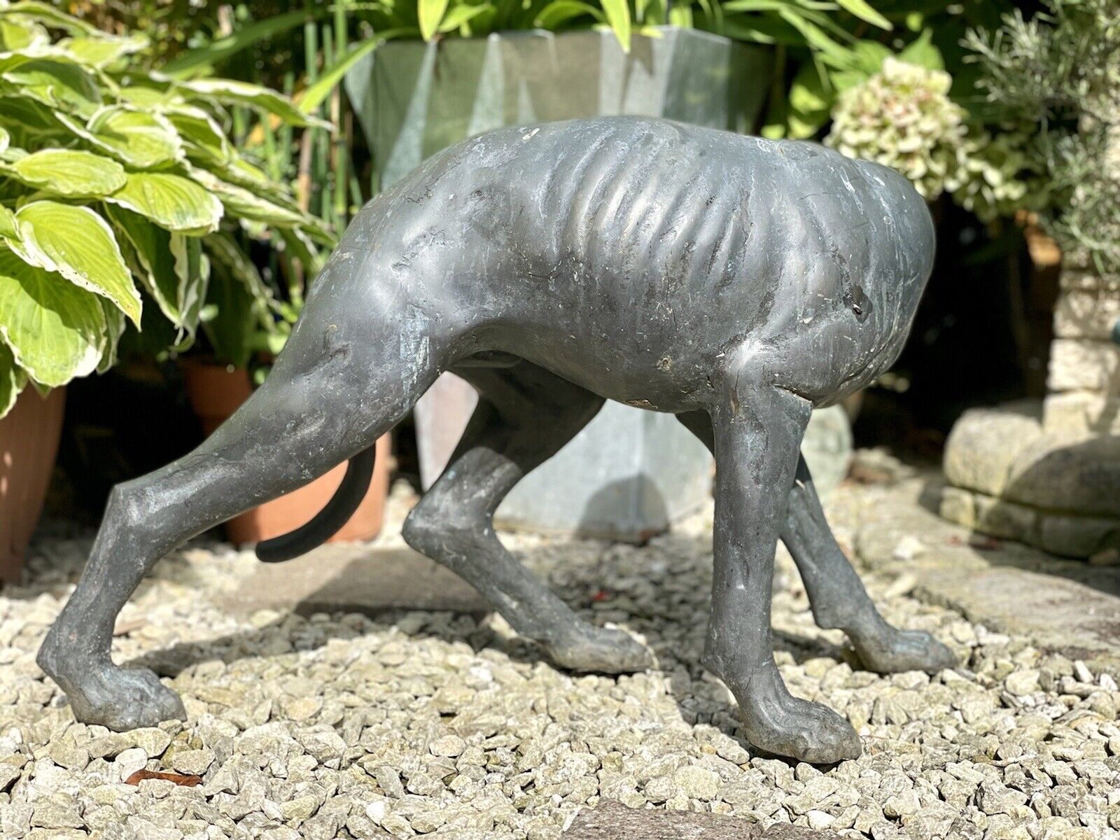 Bronzed Garden Statue of a Dog Nibbling its Rear Leg