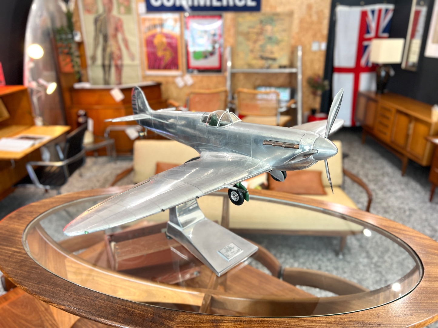 Handcrafted aluminium Spitfire aircraft model on cast aluminium stand front angled view