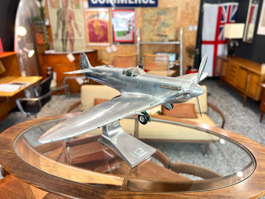 Handcrafted aluminium Spitfire aircraft model on cast aluminium stand front angled view