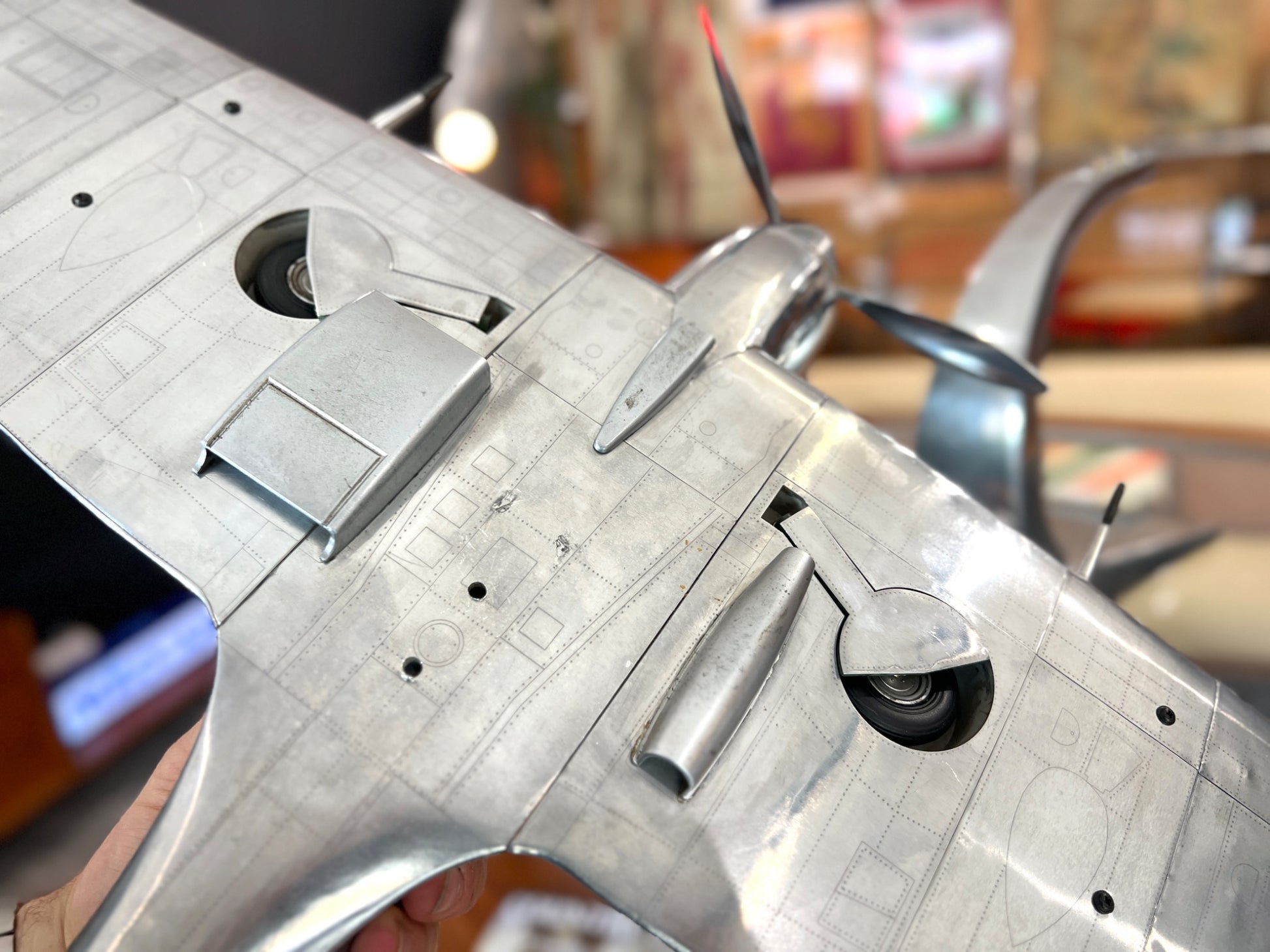 Handcrafted aluminium Spitfire aircraft model underside detail with retractable wheels