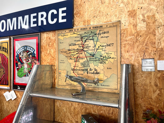 Vintage French historical school map wall chart displayed with Spitfire model