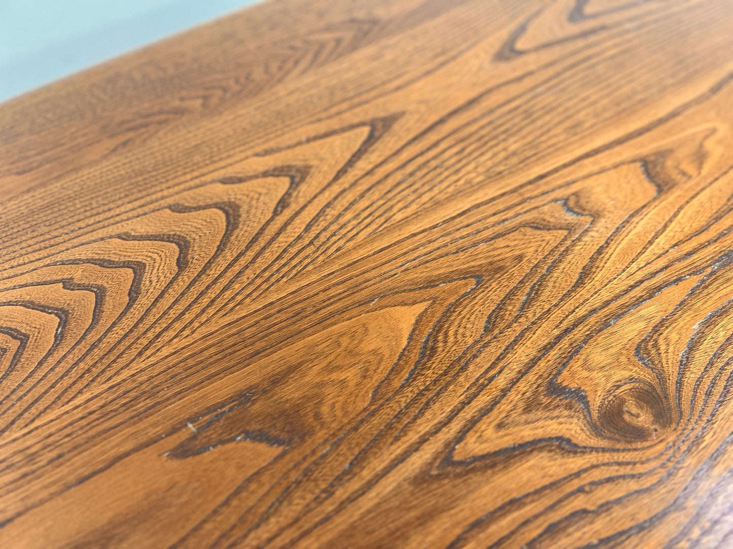 Ercol 382 dining table close up of top surface scratches