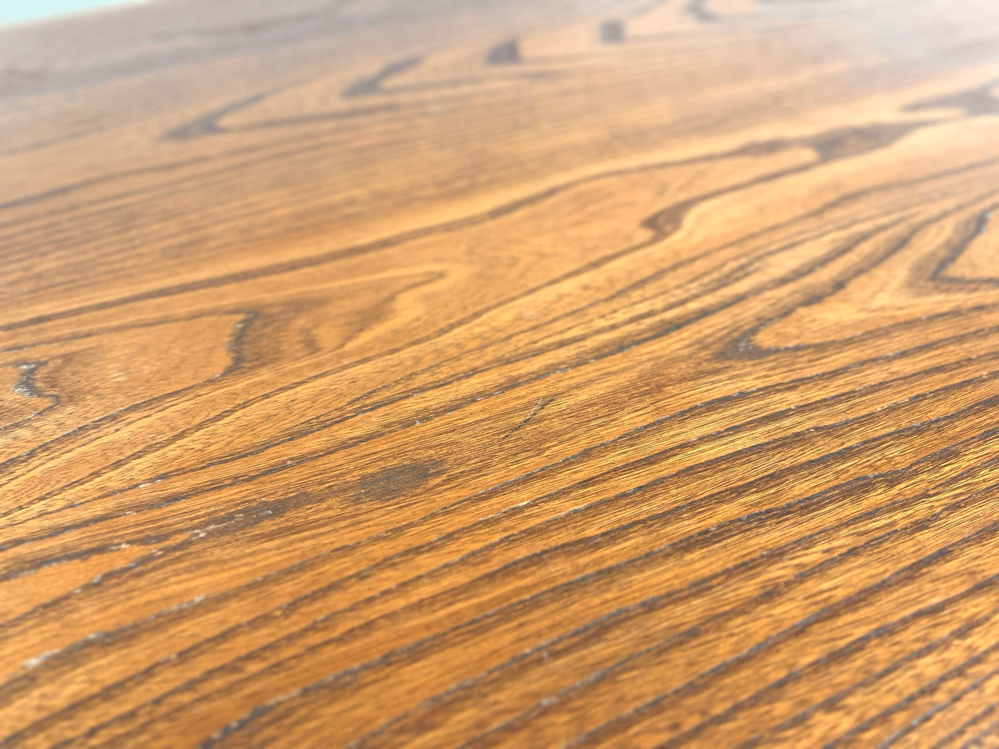 Ercol 382 dining table close up of surface blemish