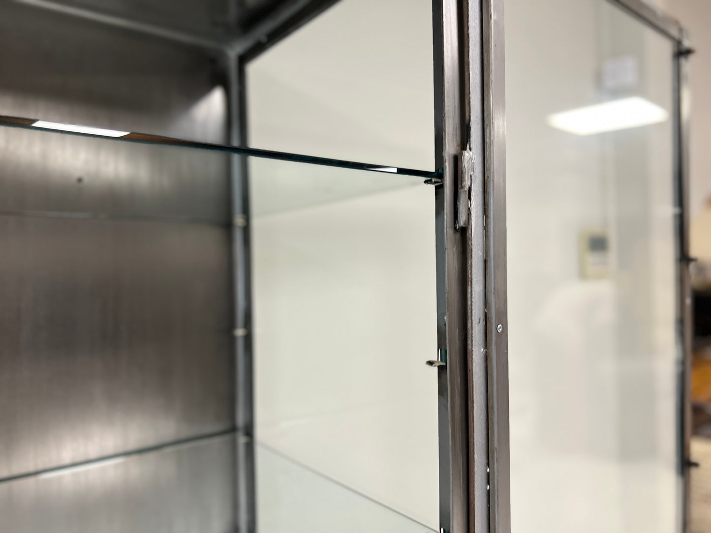 Vintage industrial steel and glass display cabinet detail