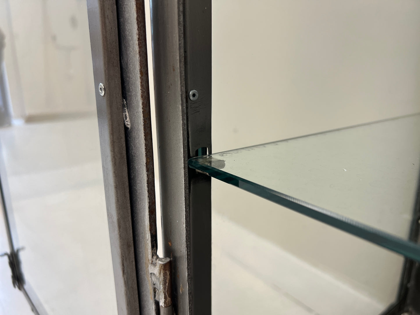Vintage industrial steel and glass display cabinet detail