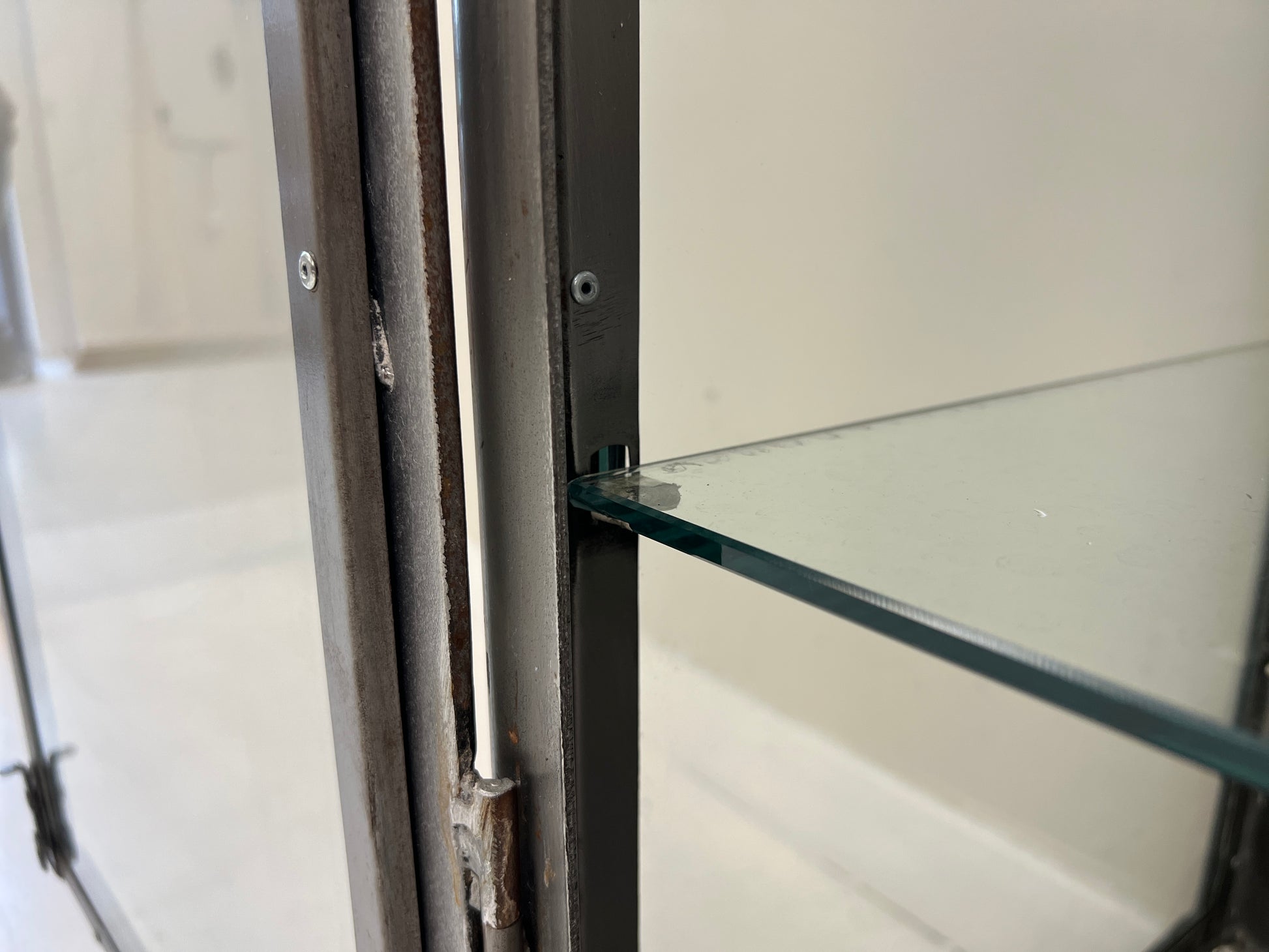 Vintage industrial steel and glass display cabinet detail