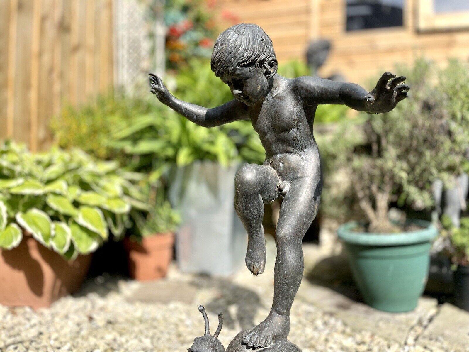 Bronzed Garden Water Feature of a Boy Stood on a Snail