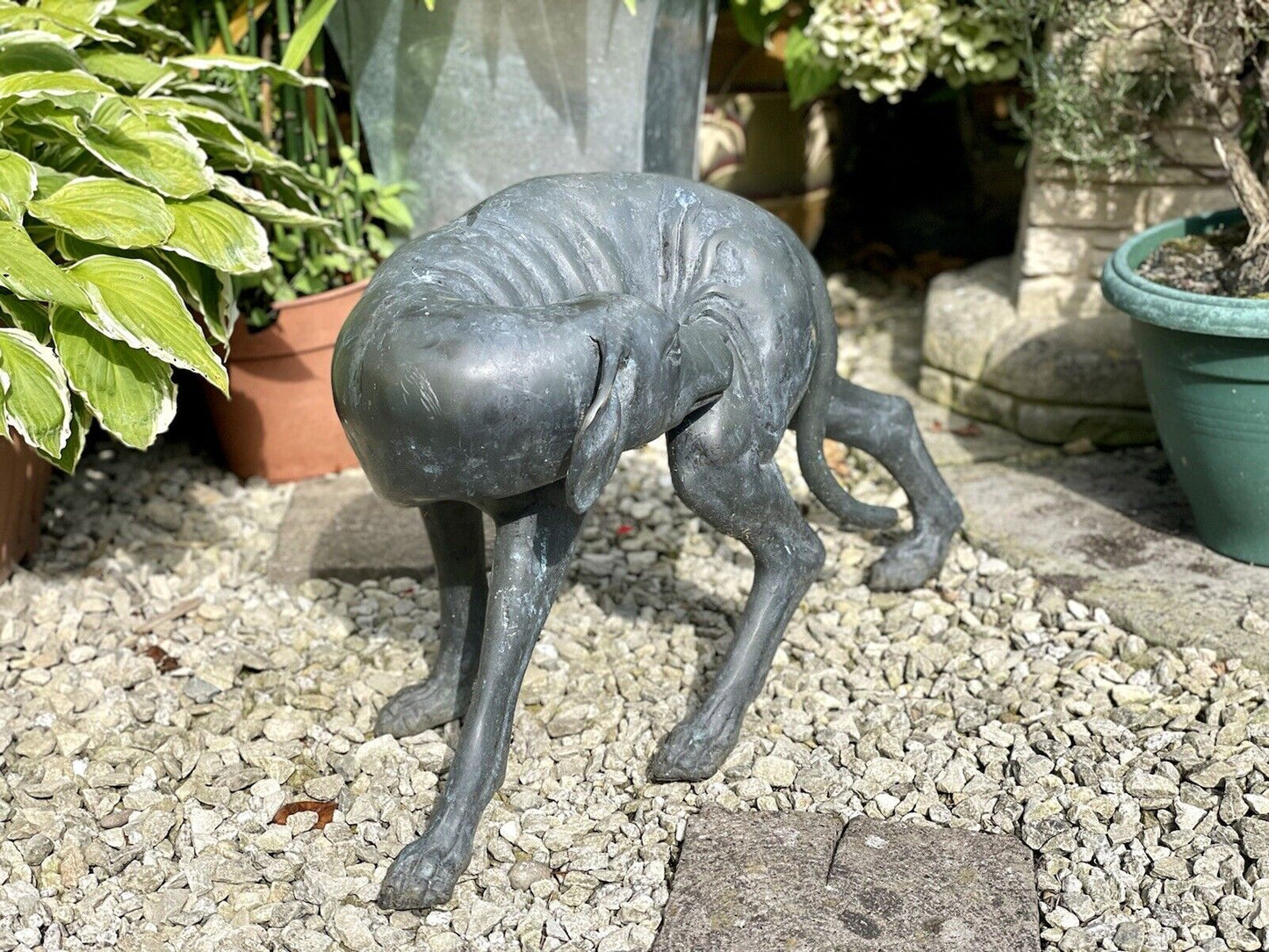 Bronzed Garden Statue of a Dog Nibbling its Rear Leg