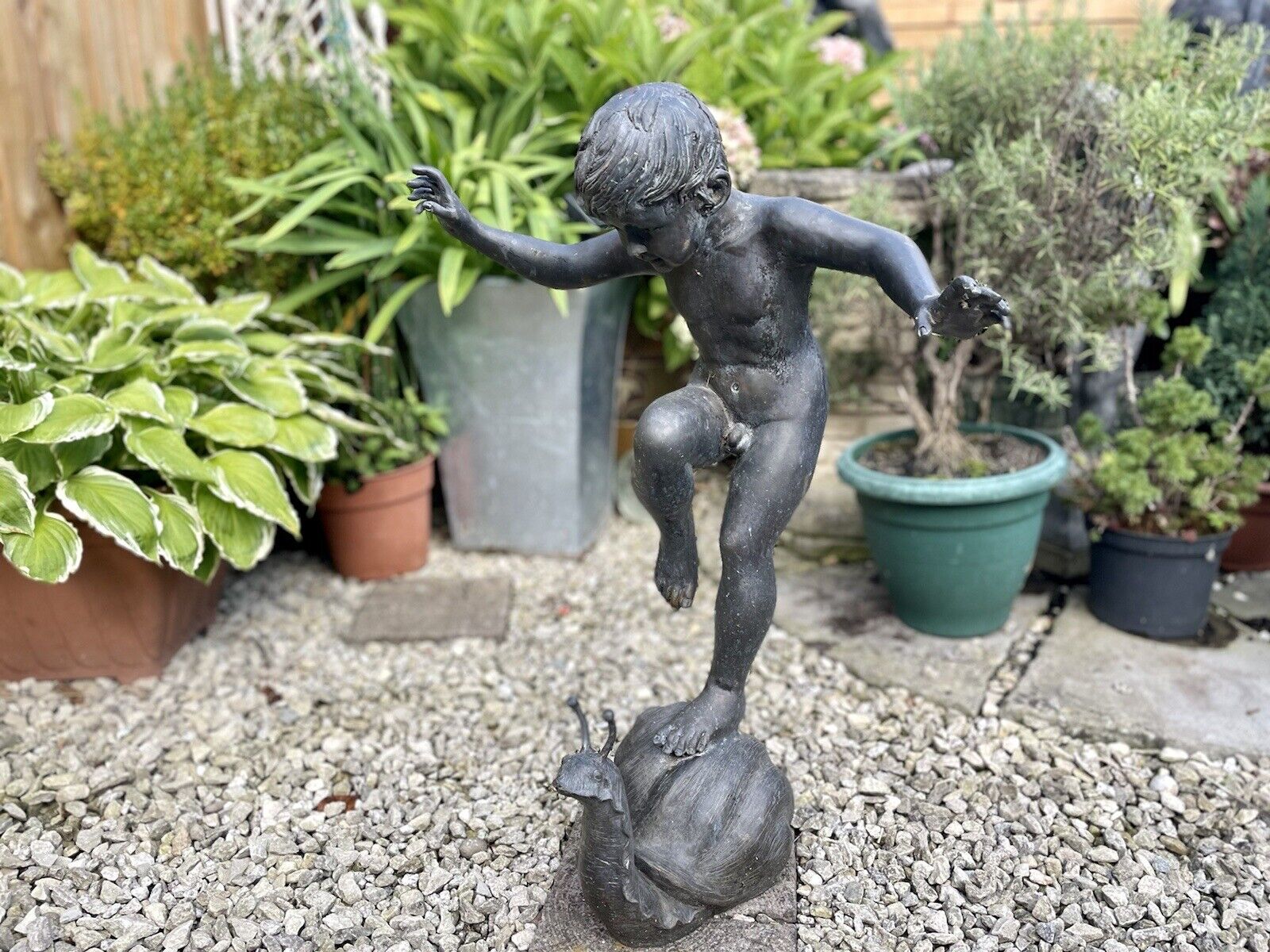 Bronzed Garden Water Feature of a Boy Stood on a Snail