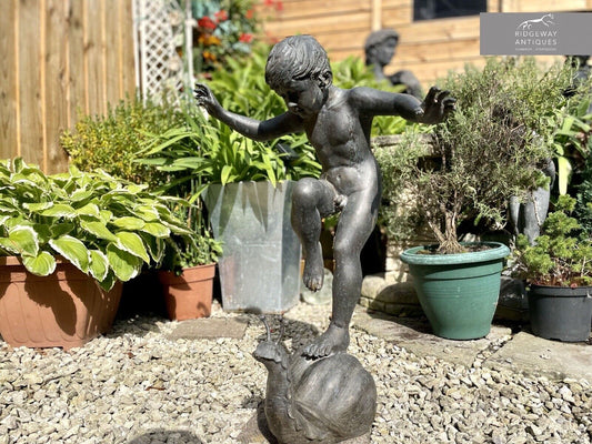Bronzed Garden Water Feature of a Boy Stood on a Snail