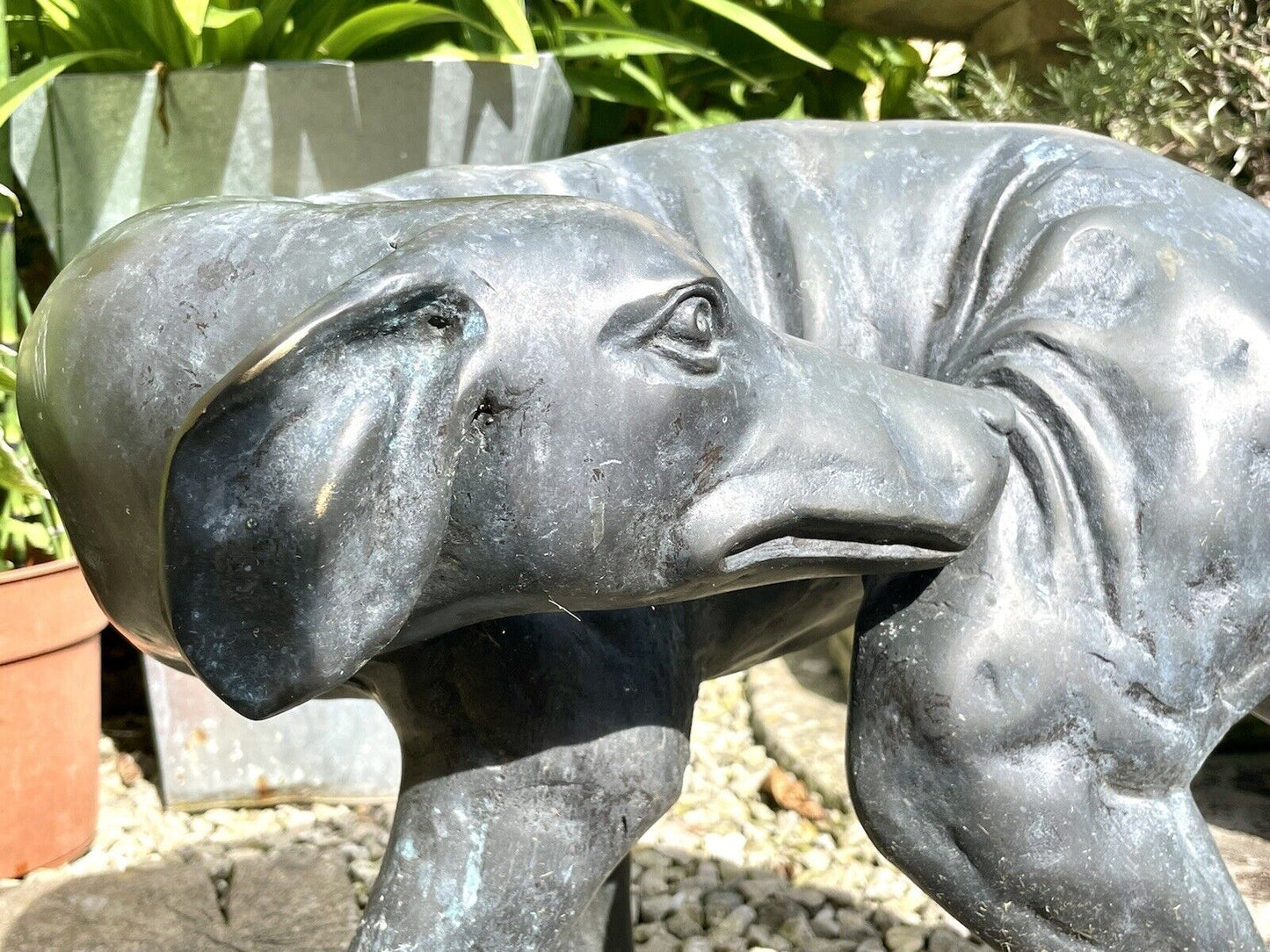 Bronzed Garden Statue of a Dog Nibbling its Rear Leg